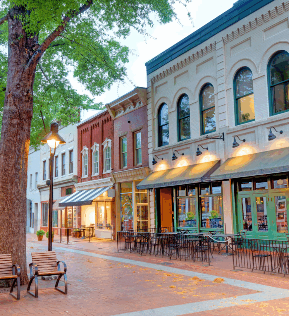 Historic downtown street with shops and benches.